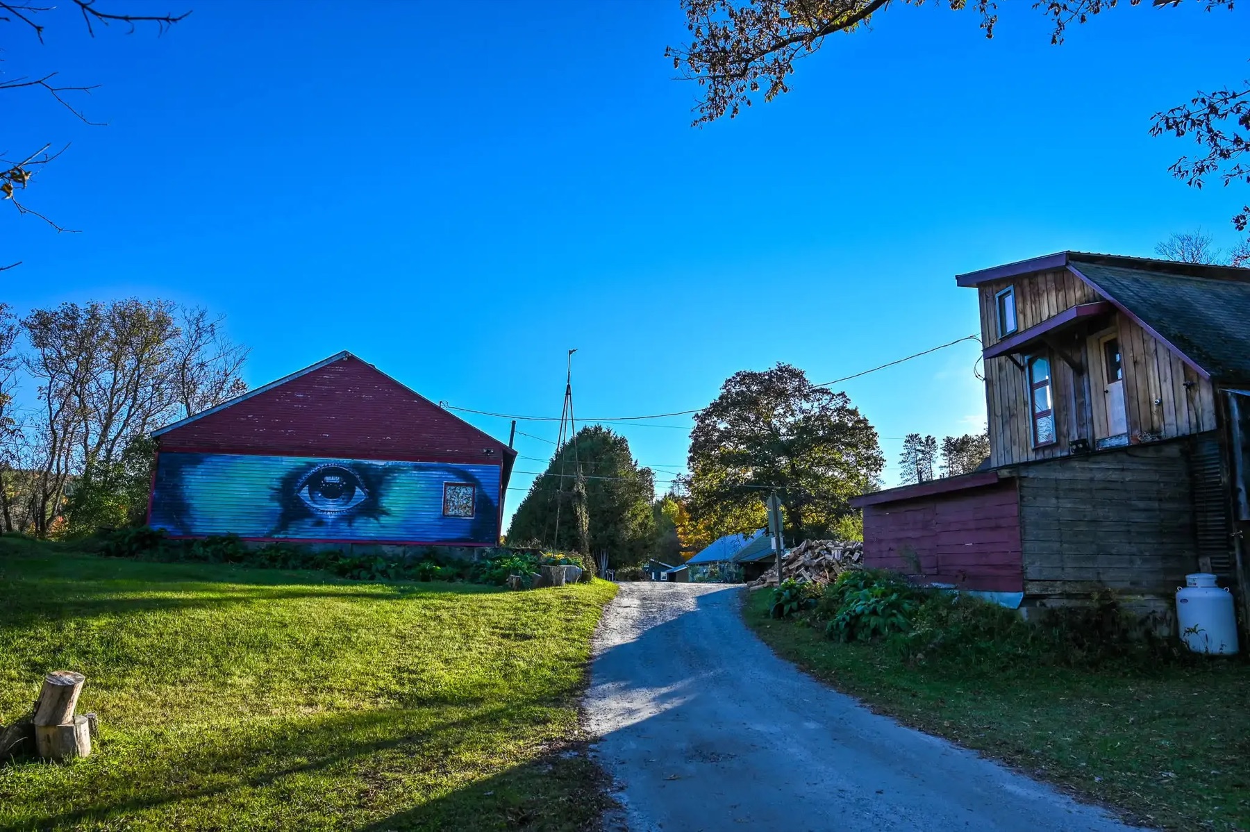 The campground's red buildings at dusk along the entry road