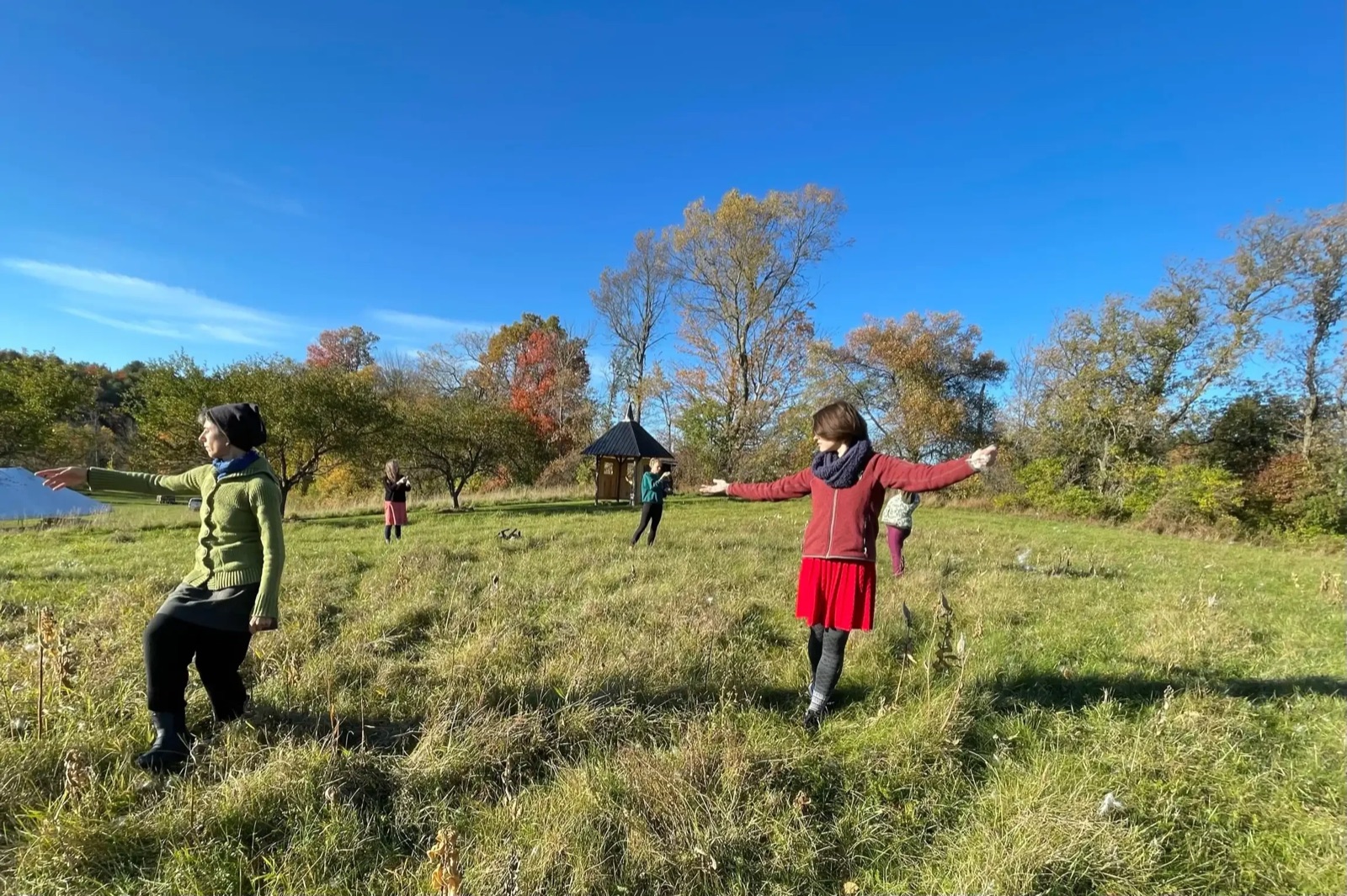 People walking the meadow trail on a bright autumn day