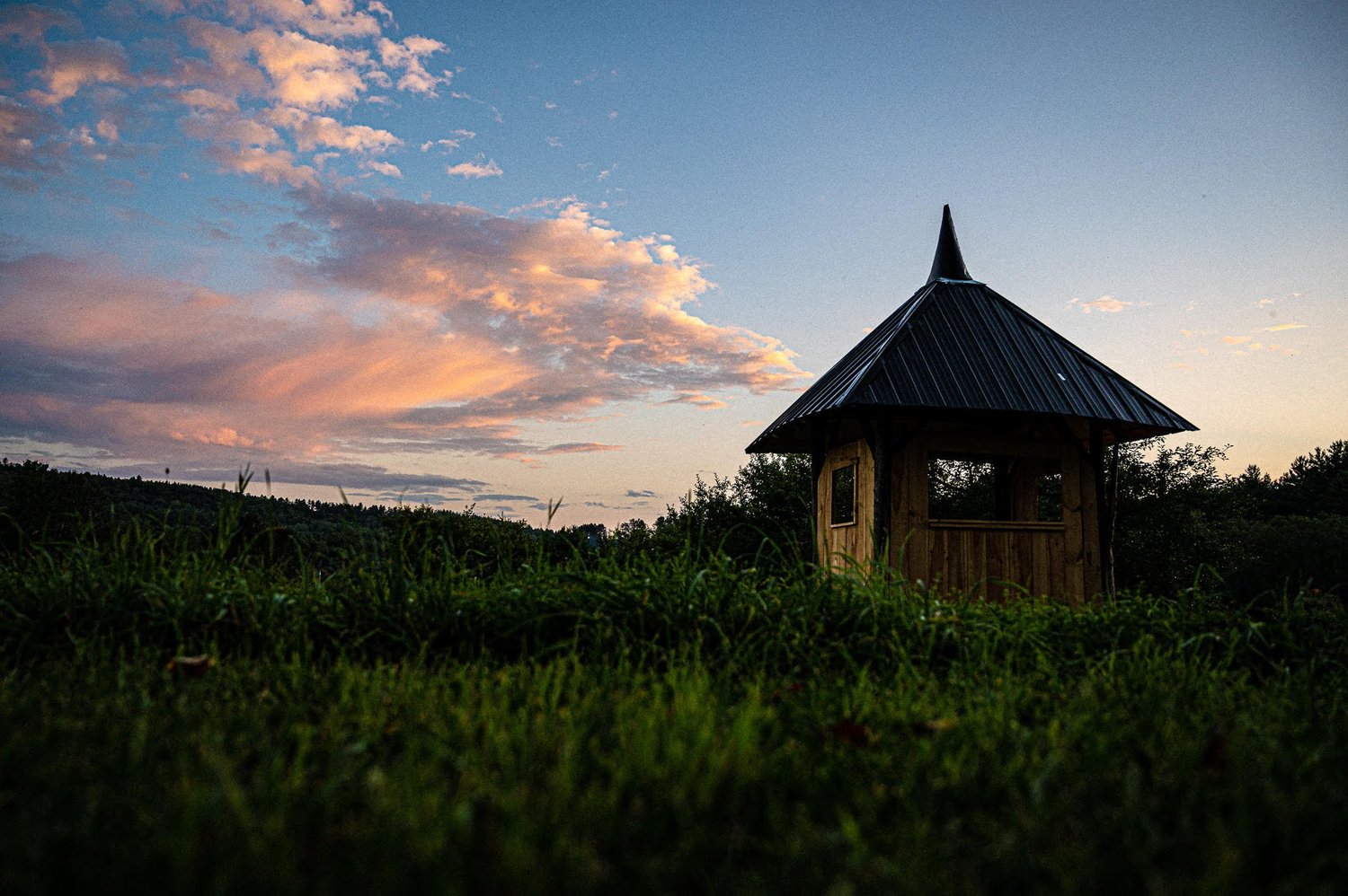 The wooden pagoda along the Elemental Commons beneath a colorful evening sky